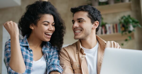 Successful ecommerce marketing with couple staring at laptop