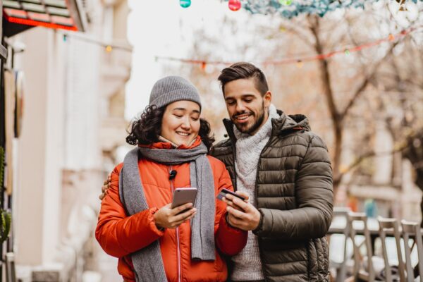 Buyer Persona - woman and man shopping walking down street with credit card