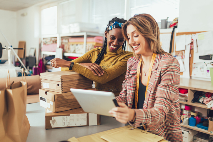 Two sales people checking on Instagram ad engagement