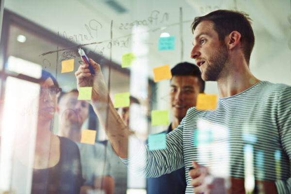 Young professionals looking at product content strategy sticky notes